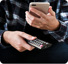 Person holding phone and remove control