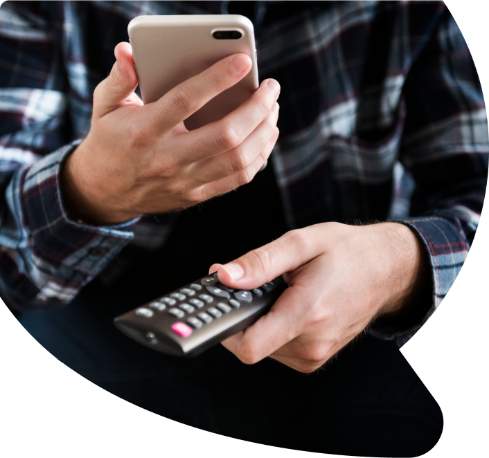 Person holding phone and remove control