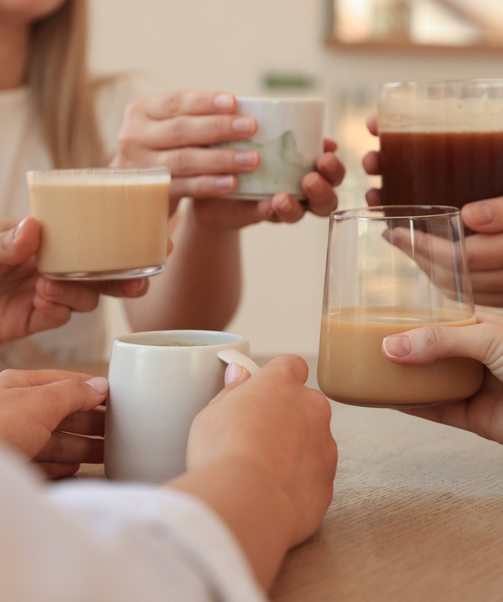 friends-drinking-coffee-at-wooden-table-in-cafe-c-2026-03-27-01-39-08-utc copy